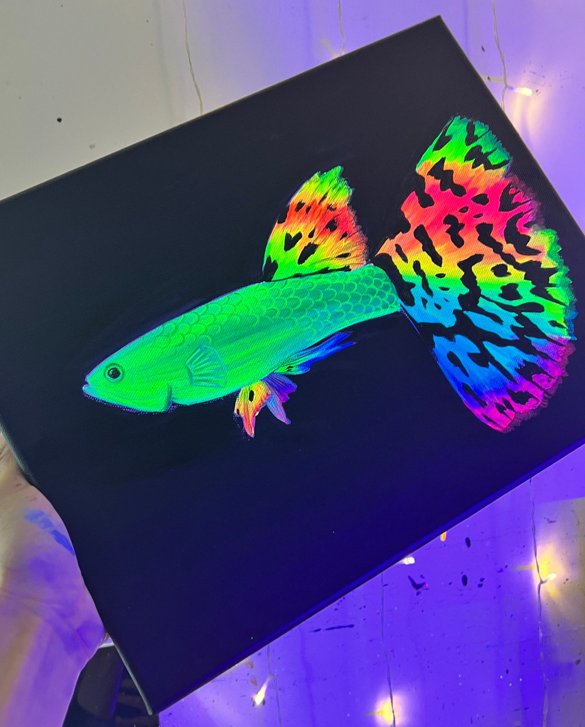 Rainbow guppy black light painting side view